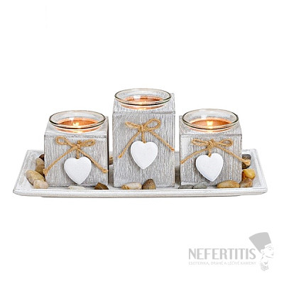 Set of three wooden candlesticks on a tray